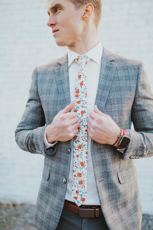 Citrus tie worn with a white shirt, gray plaid blazer and gray pants.