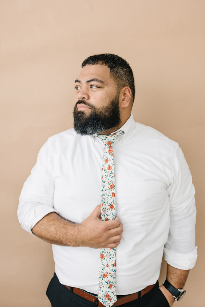Citrus tie worn with a white shirt, brown belt and black pants.