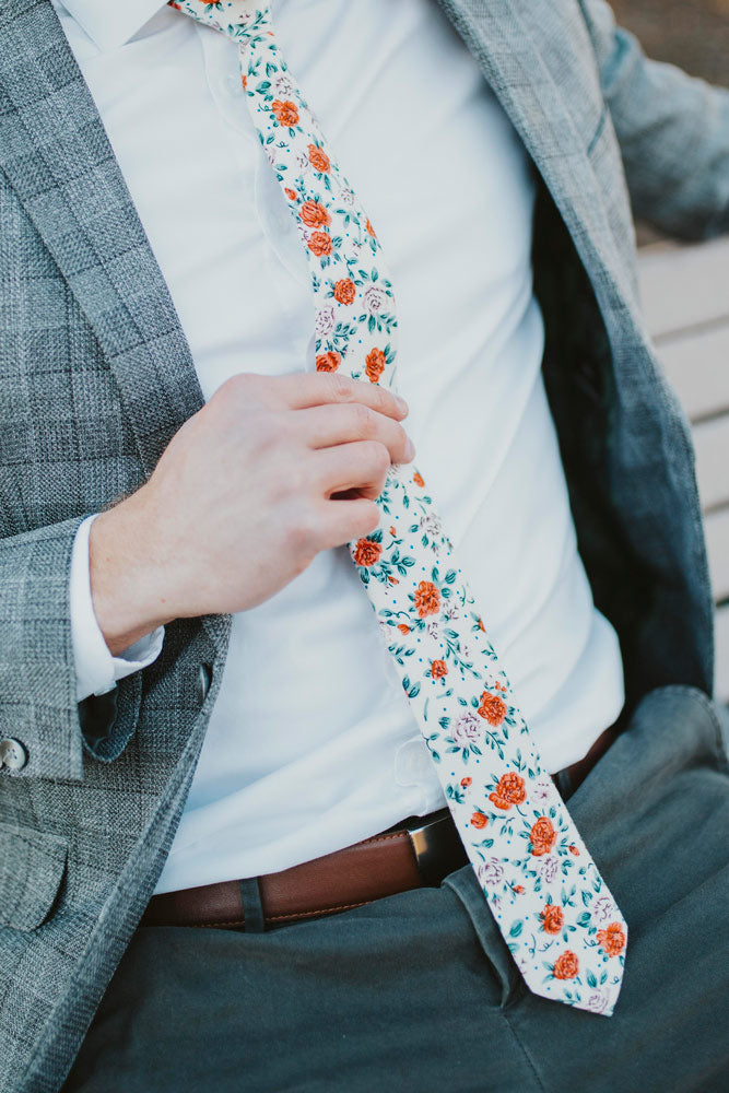 Citrus tie worn with a white shirt, gray plaid blazer and gray pants.