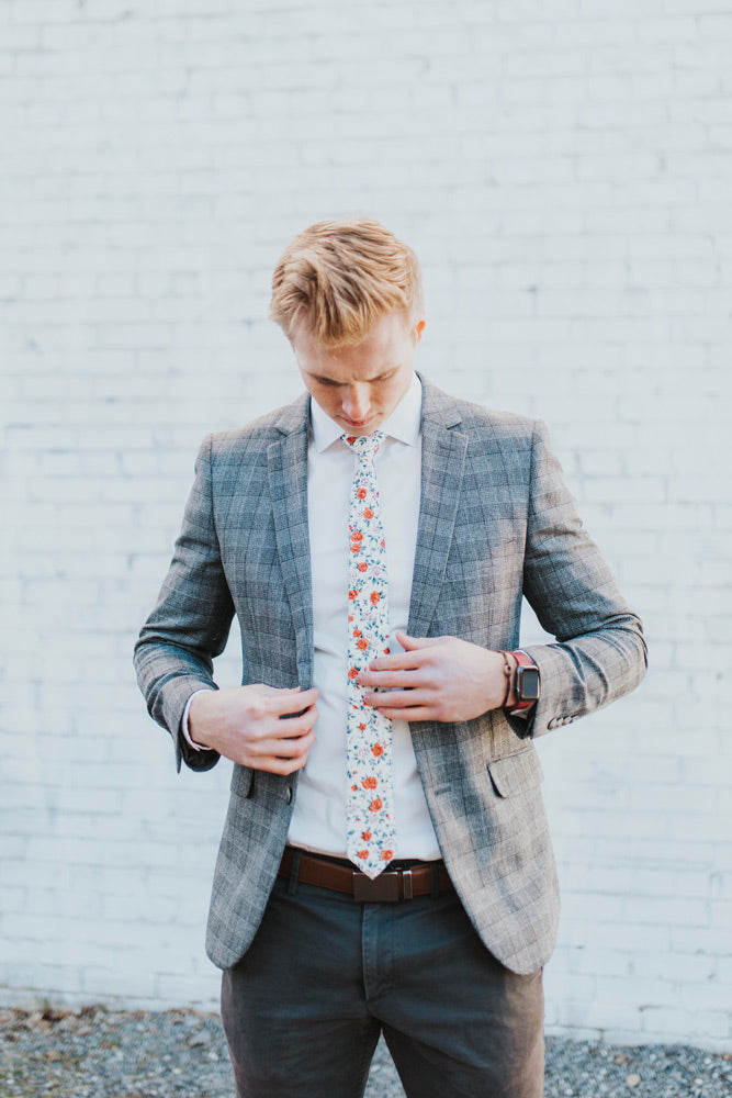 Citrus tie worn with a white shirt, gray plaid blazer and gray pants.