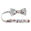 Citrus Pre-Tied Bow Tie with adjustable neck strap. Off white background with pink and orange flowers and light gray leaves throughout.