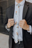 Copper Blooms tie worn with a white shirt and black suit.