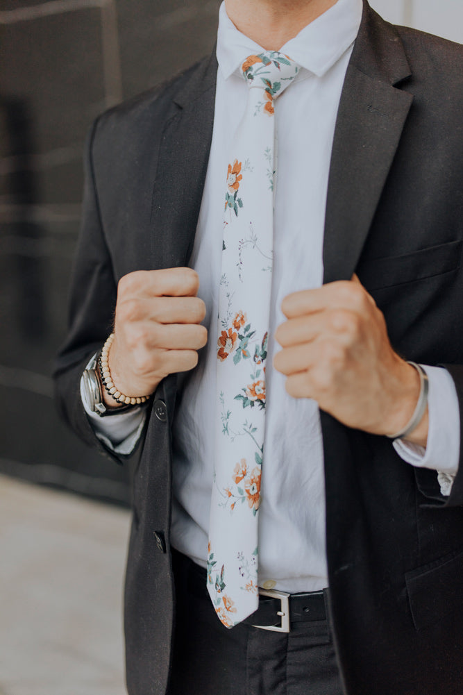 Copper Blooms tie worn with a white shirt and black suit.