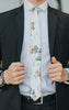 Copper Blooms tie worn with a white shirt and black suit.
