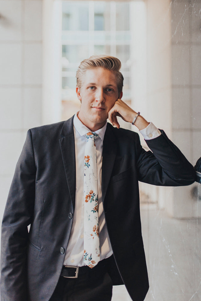 Copper Blooms tie worn with a white shirt and black suit.