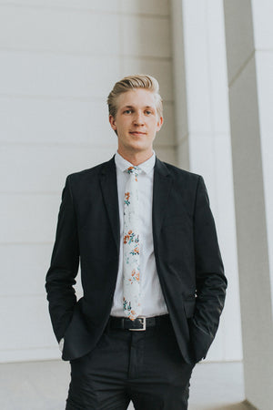 Copper Blooms tie worn with a white shirt and black suit.