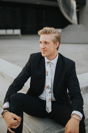 Copper Blooms tie worn with a white shirt and black suit.