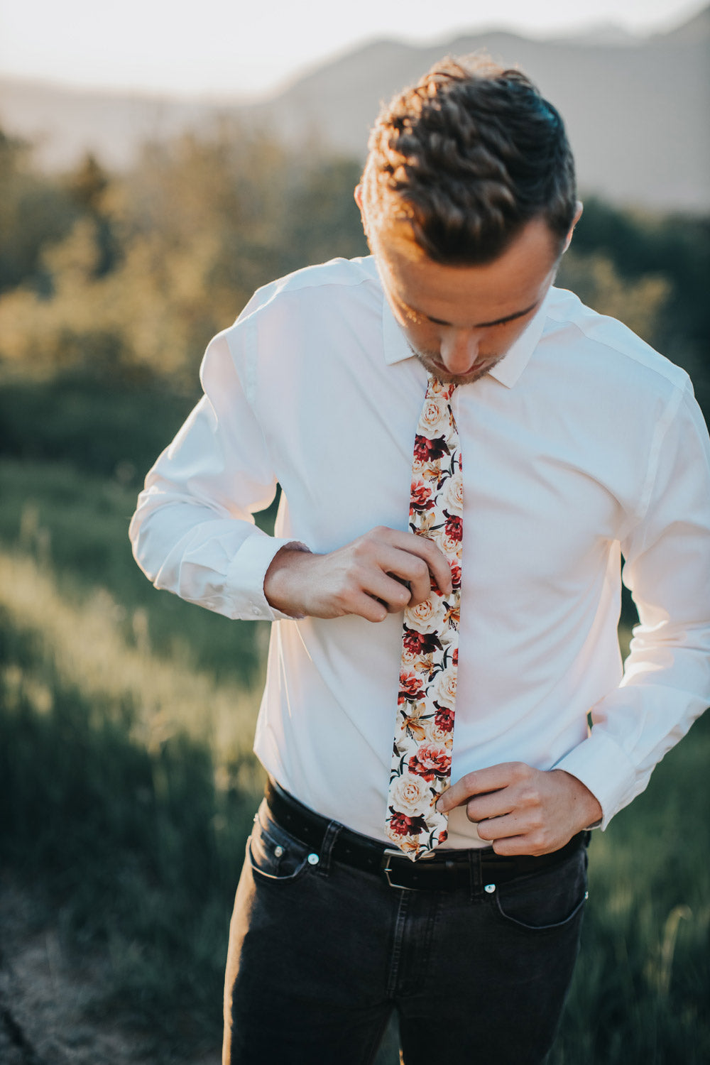 Coral Void tie worn with a white shirt, black belt and black pants. 