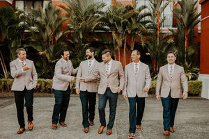 Coral Void tie worn by 6 groomsmen with a white shirt, tan suit jacket, navy blue pants and brown leather shoes.