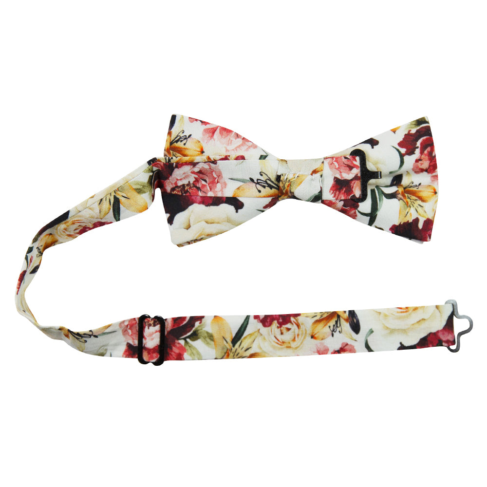 Coral Void Pre-Tied Bow Tie with adjustable neck strap. White background with ivory, maroon and gold flowers and green stems and leaves. 