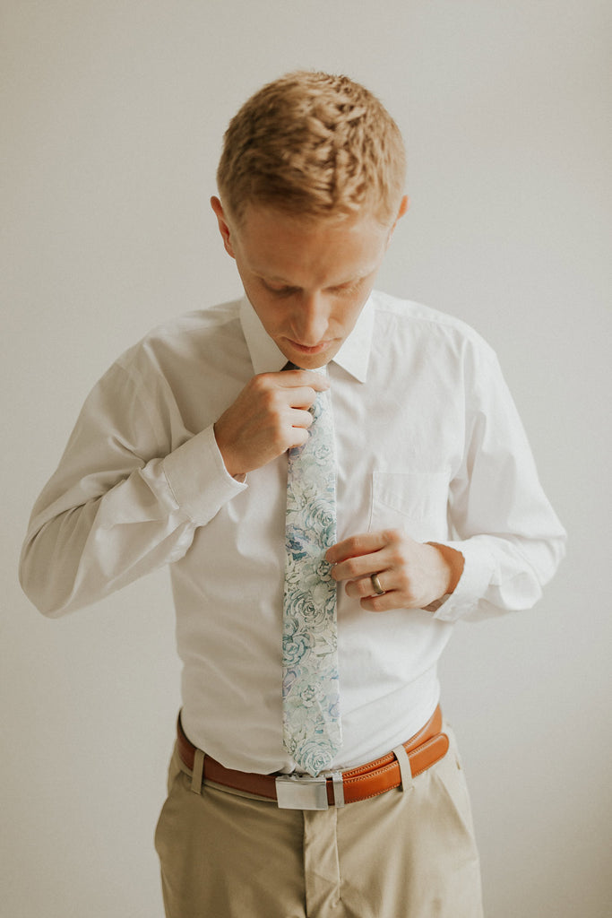 Crested Sunburst tie worn with a white shirt, brown belt and khaki pants.