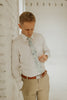 Crested Sunburst tie worn with a white shirt, brown belt and khaki pants.
