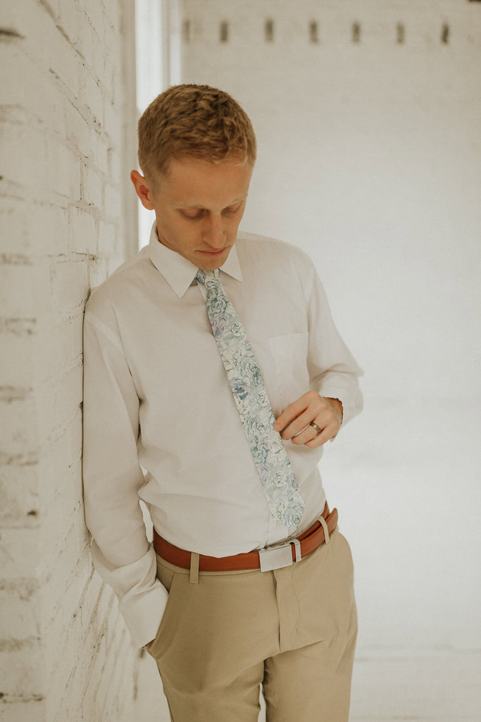 Crested Sunburst tie worn with a white shirt, brown belt and khaki pants.