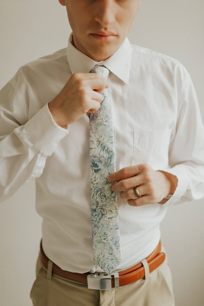 Crested Sunburst tie worn with a white shirt, brown belt and khaki pants.