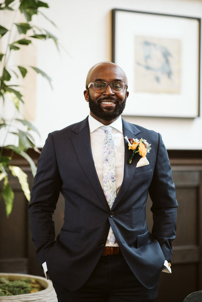 Crested Sunburst tie worn with a white shirt, blue suit jacket and blue pants at a wedding.