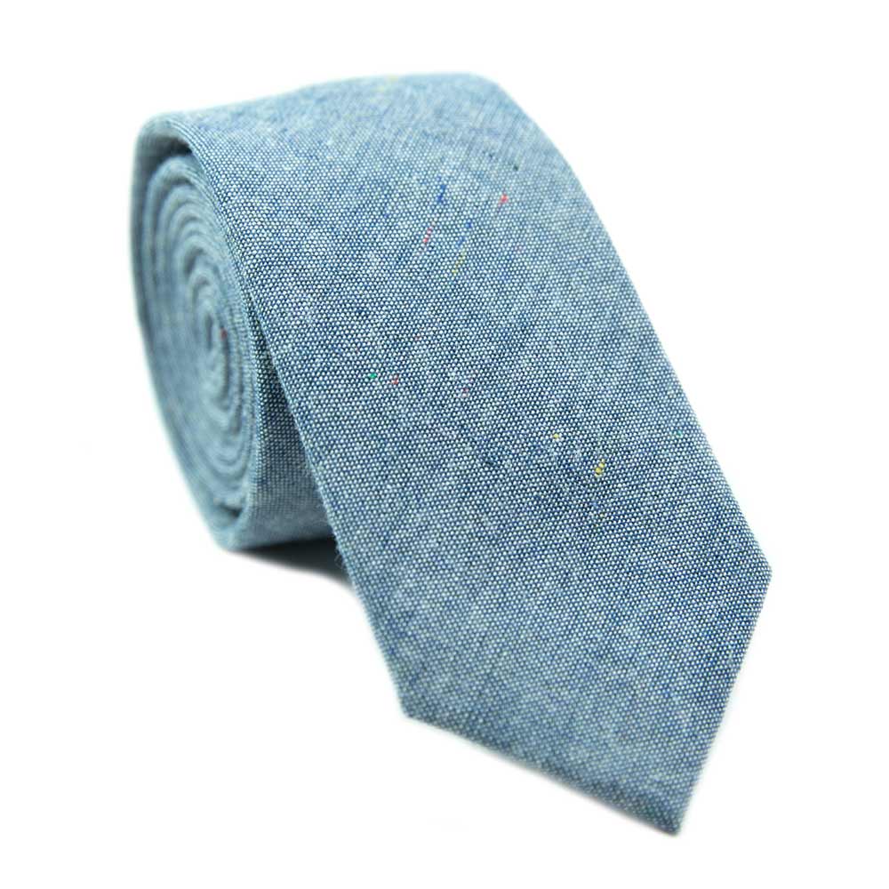 Crew skinny tie. Blue textured background with small spots of navy, yellow and red.