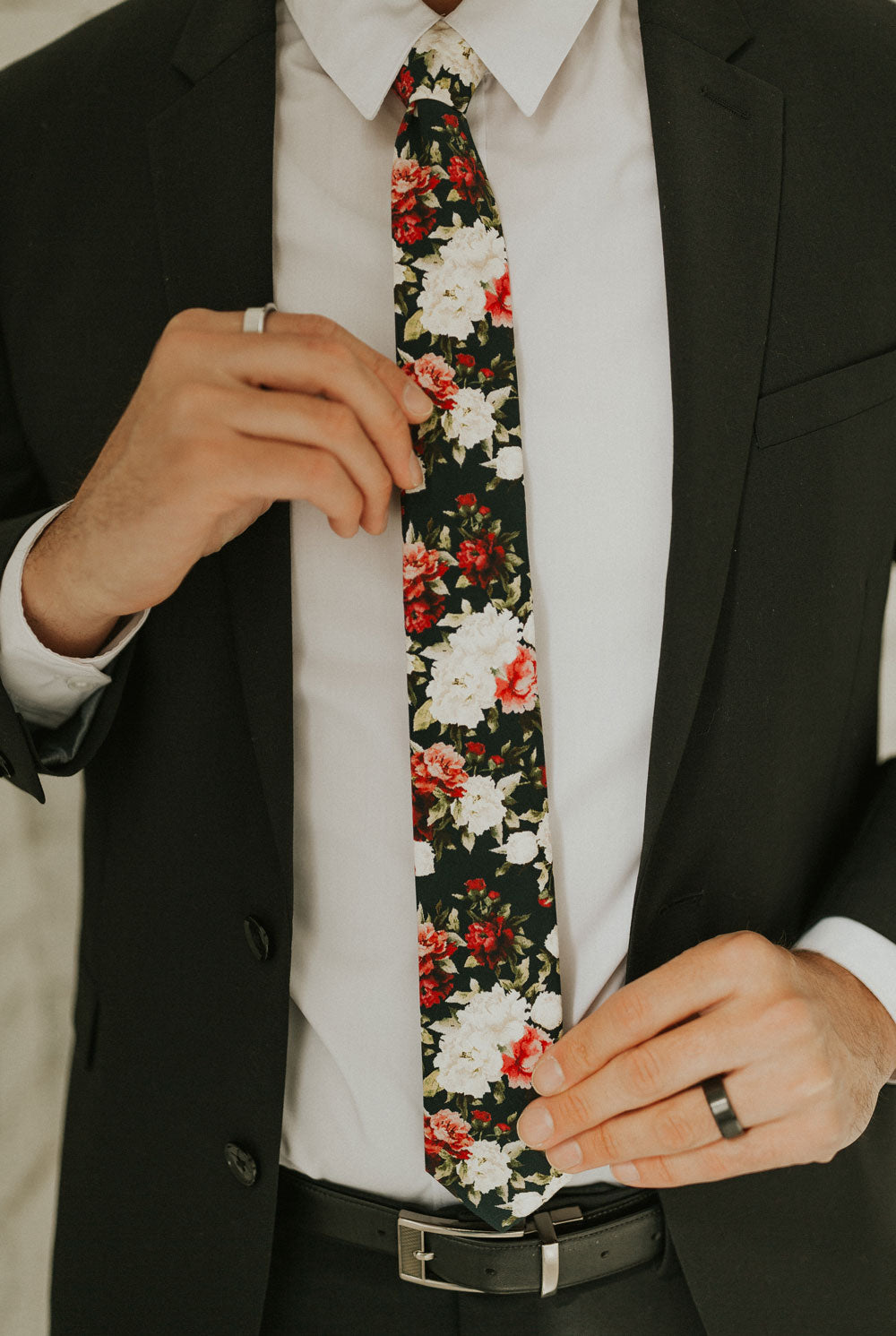 Crimson Rose tie worn with a white shirt, black suit jacket, black belt and black pants.