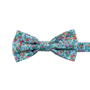 Dahlia Pre-Tied Bow Tie. Light blue background with a variety of small pink, red, salmon and white flowers and green leaves. 