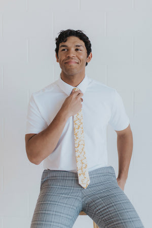 Daisy Tie worn with a white shirt and gray plaid suit pants.