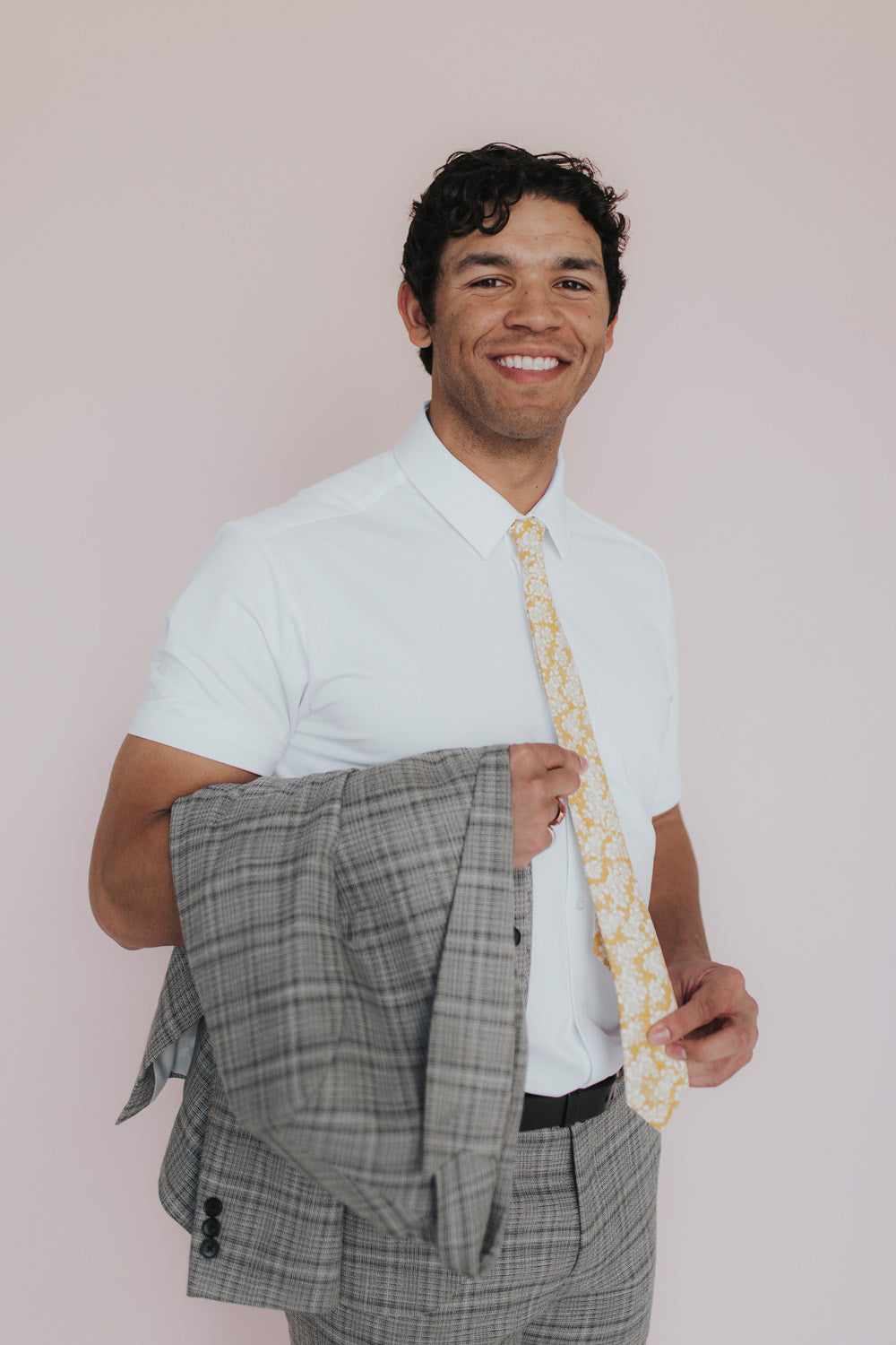 Daisy Tie worn with a white shirt and gray plaid suit.