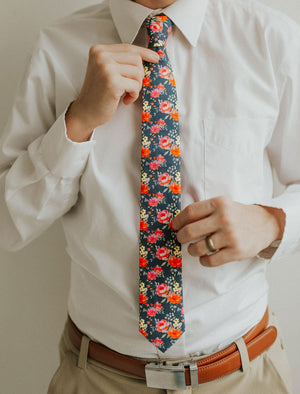 Daybreak tie worn with a white shirt, brown belt and khaki pants.