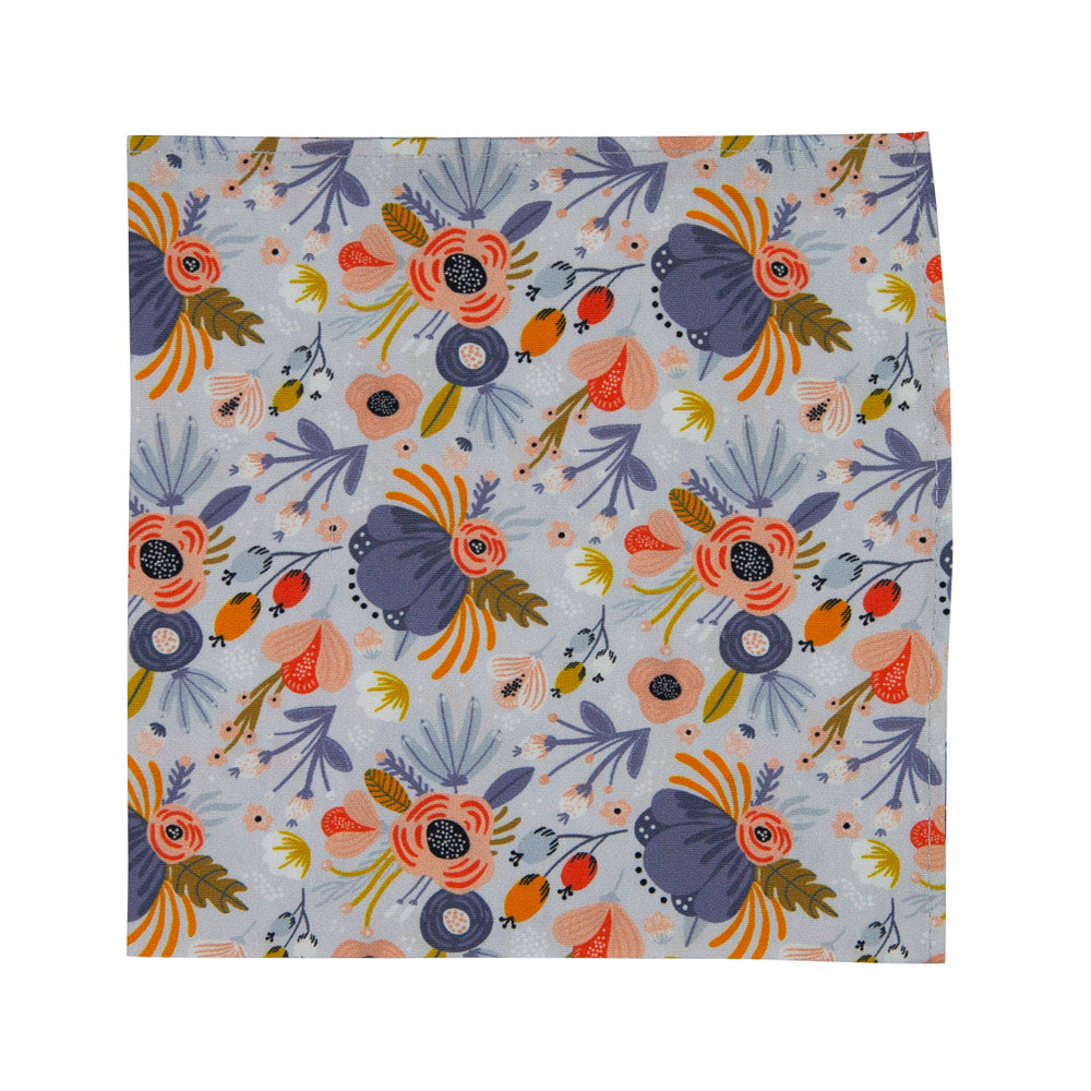 Desert Poppy Pocket Square. Dusty blue background with painted flowers of various colors such as blue, orange, pink, peach and gold.