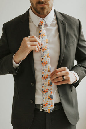 Desert Poppy tie worn with a white shirt, black suit jacket, black belt and black pants.