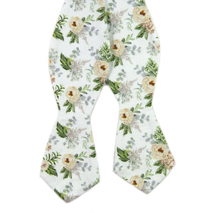 Desert Sun Self Tie Bow Tie. White background with round yellow flowers, green and silver leaves. 