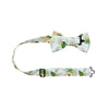 Desert Sun Pre-Tied Bow Tie with adjustable neck strap. White background with round yellow flowers, green and silver leaves. 