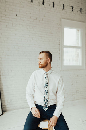 Dreamy Fields tie worn with a white shirt and black pants. 