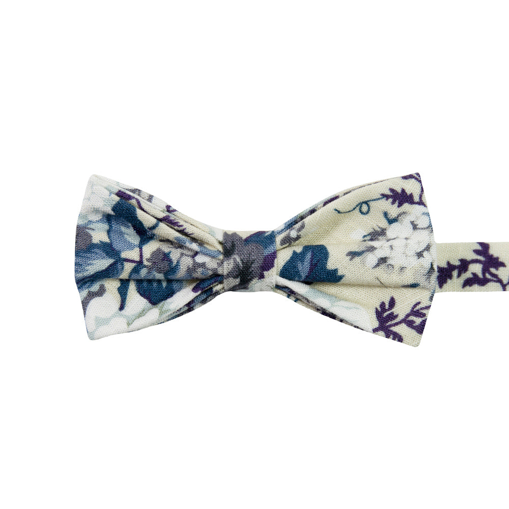 Dreamy Fields Pre-Tied Bow Tie. Cream background with dusty blue, white and gray flowers with navy blue and purple leaves.