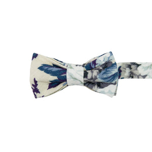 Dreamy Fields Pre-Tied Bow Tie. Cream background with dusty blue, white and gray flowers with navy blue and purple leaves.