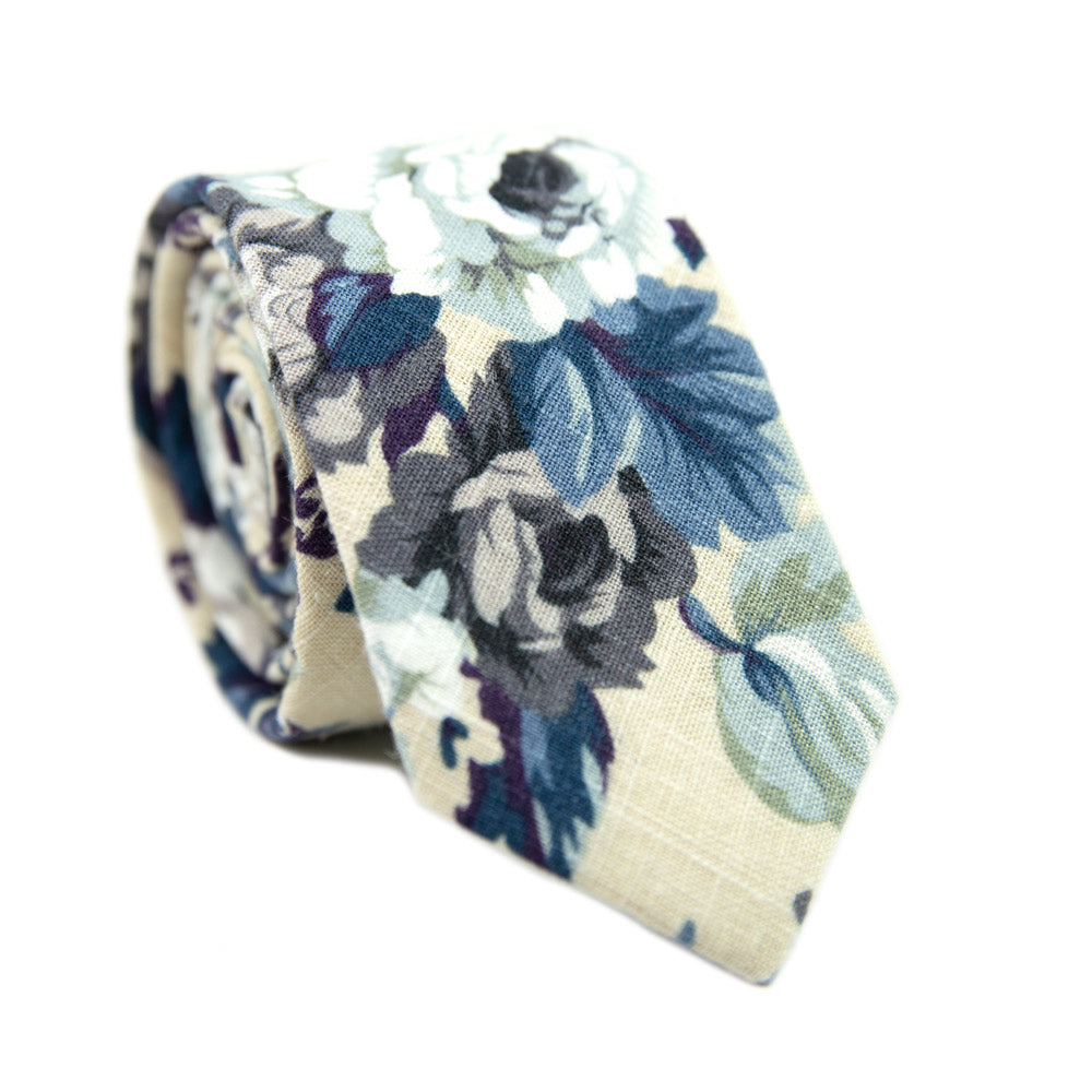 Dreamy Fields Skinny Tie. Cream background with dusty blue, white and gray flowers with navy blue and purple leaves.