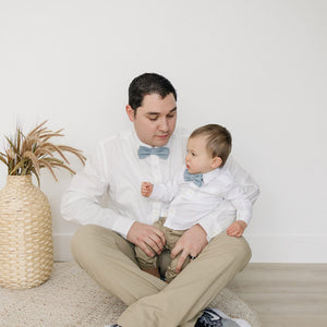 Dusty Pre-Tied bow ties worn by a father and son wearing white shirts and tan pants. 