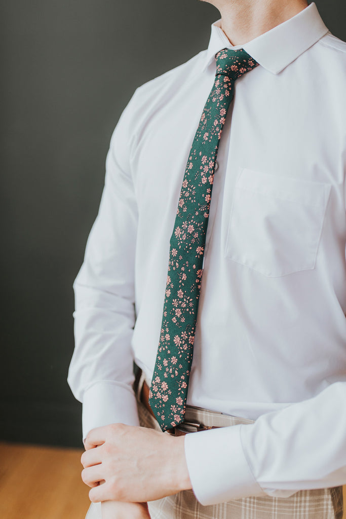 Evergreen tie worn with a white shirt, brown belt and tan and white plaid pants.