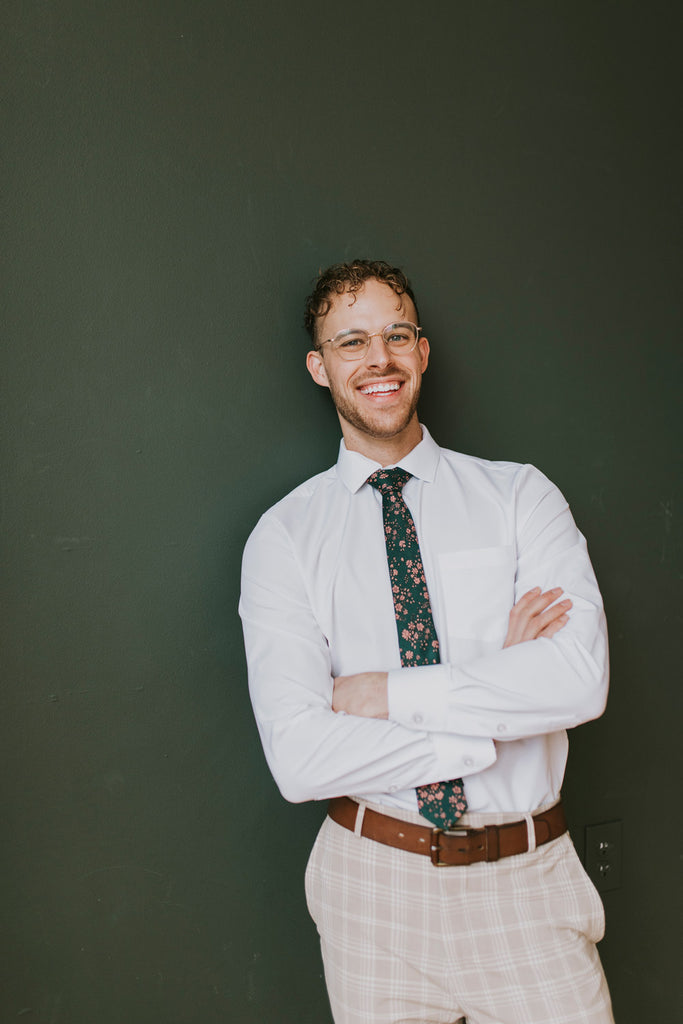 Evergreen tie worn with a white shirt, brown belt and tan and white plaid pants.