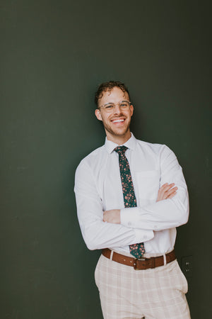Evergreen tie worn with a white shirt, brown belt and tan and white plaid pants.