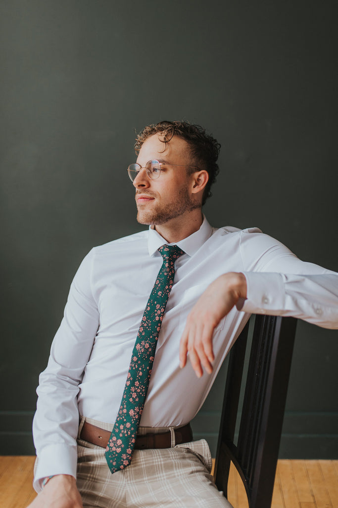 Evergreen tie worn with a white shirt, brown belt and tan and white plaid pants.