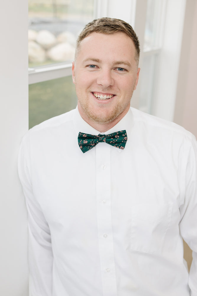 Evergreen pre-tied bow tie worn with a white shirt.