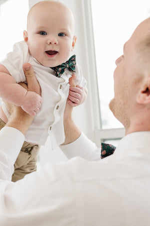 Evergreen pre-tied bow tie worn by a father and son with a white shirt and tan pants.