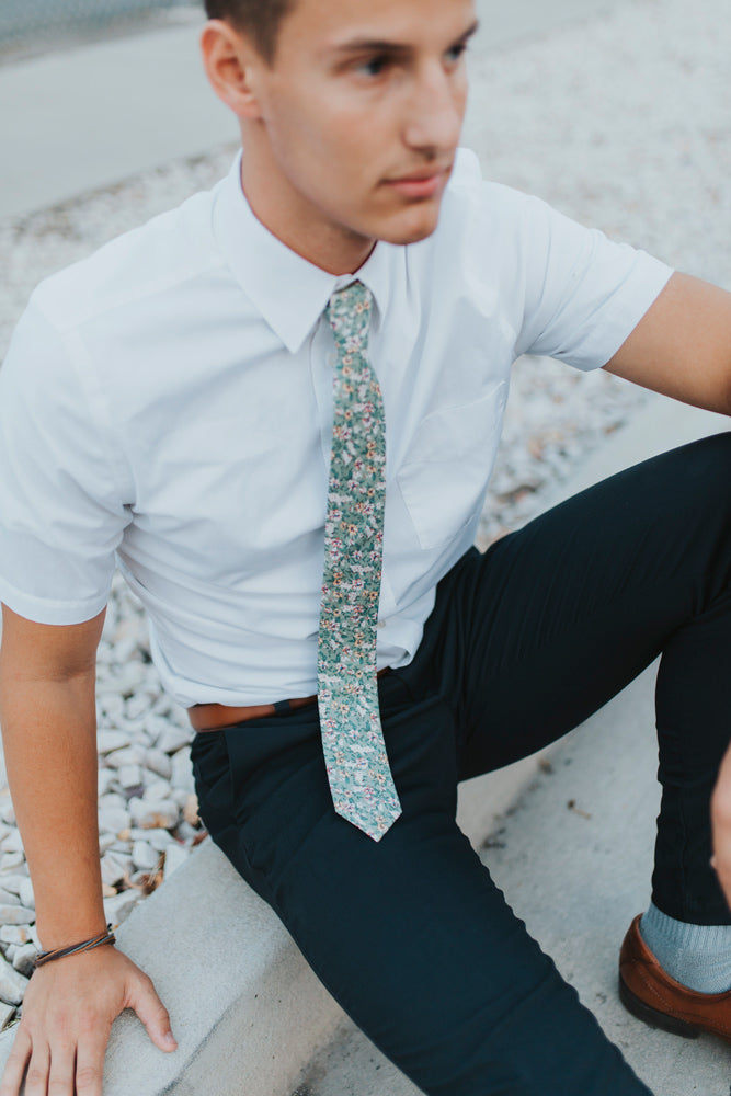 Faded Jade tie worn with a white shirt and navy blue pants.
