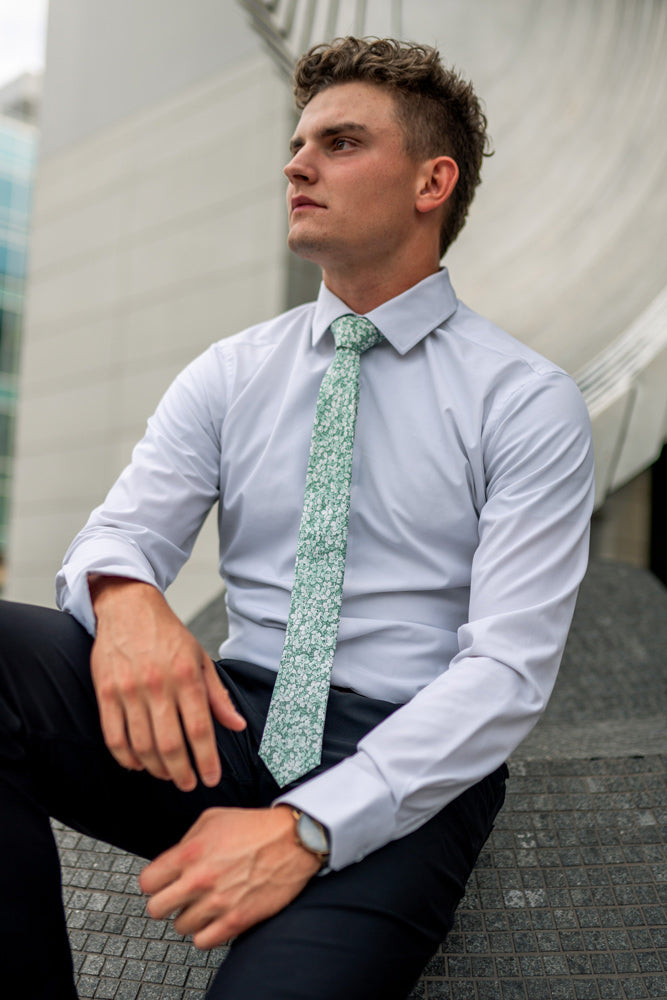 Feelin Lucky tie worn with a white shirt and navy blue pants.