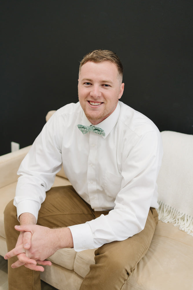 Feelin Lucky pre-tied bow tie worn with a white shirt and tan pants.