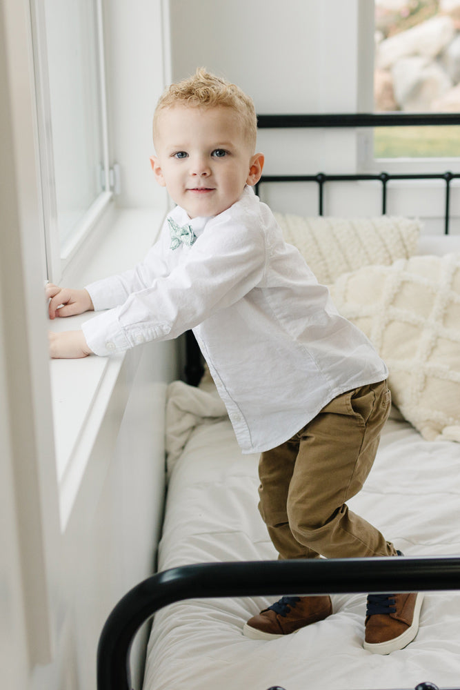 Feelin Lucky pre-tied bow tie worn with a white shirt and tan pants, brown shoes.