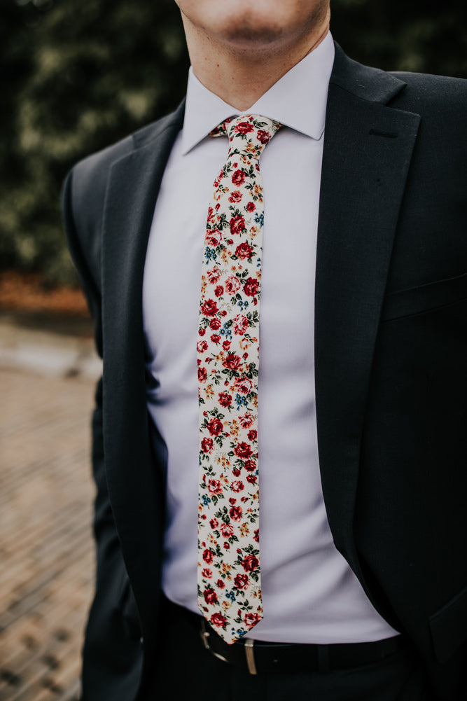 Fiore tie worn with a white shirt and black suit. 