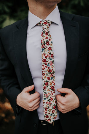 Fiore tie worn with a white shirt and black suit. 