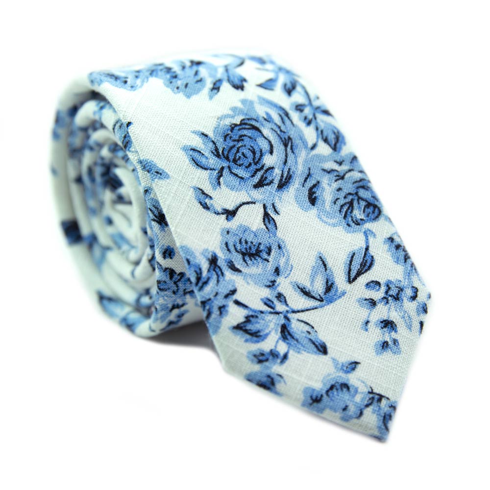 French Garden Skinny Tie. Textured white background with light blue flowers and leaves.