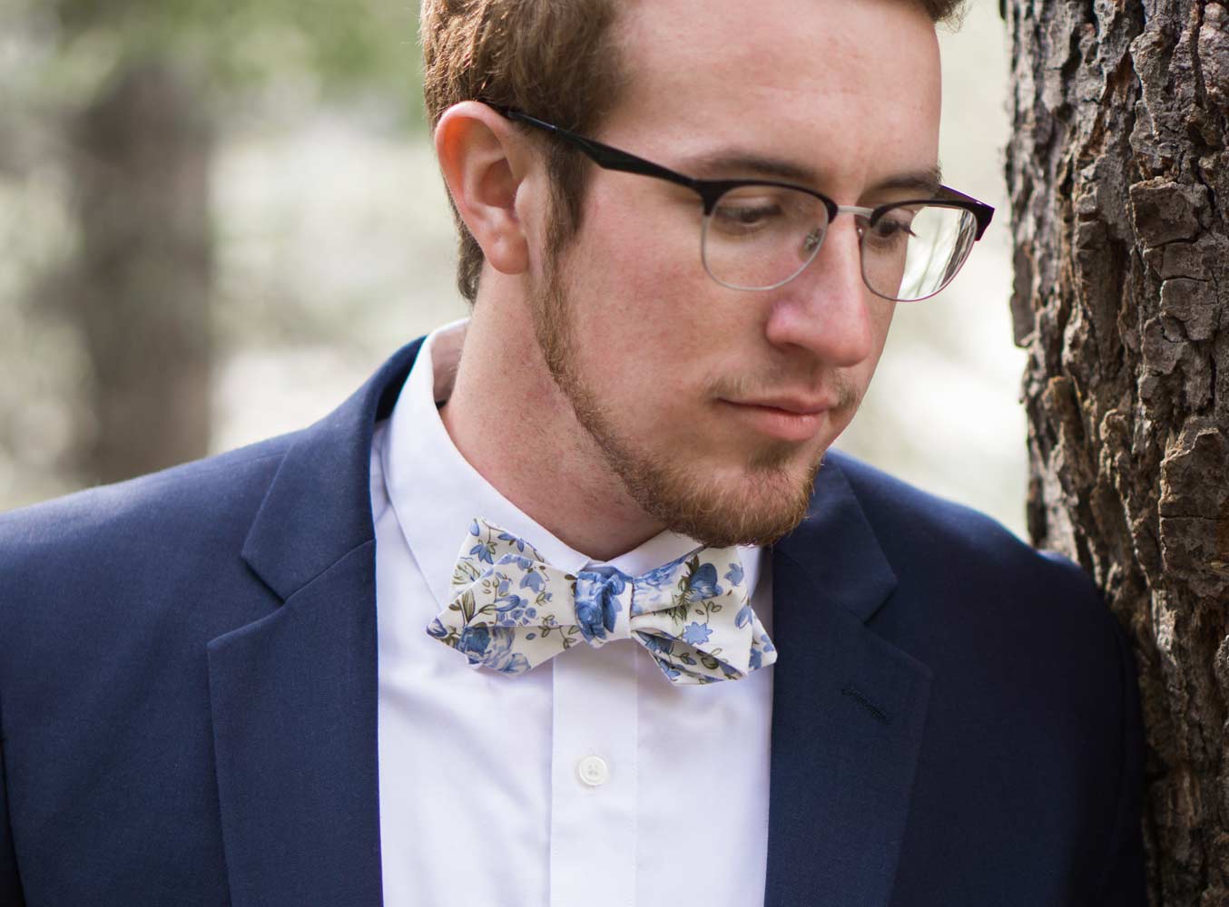 Frisco Bow Tie worn with a white shirt and navy blue suit jacket.
