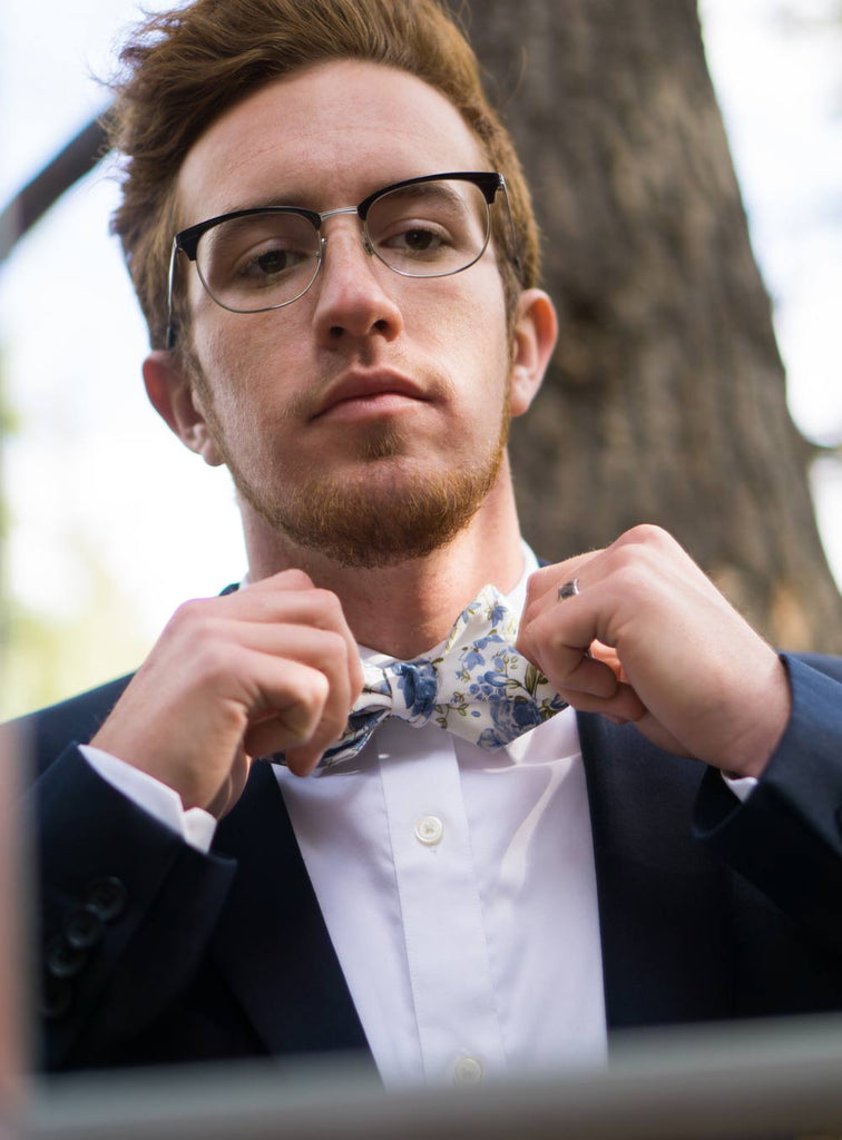 Frisco Bow Tie worn with a white shirt and navy blue suit jacket.