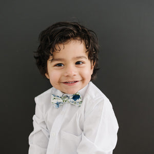 Frisco pre-tied bow tie on a young boy wearing a white shirt.